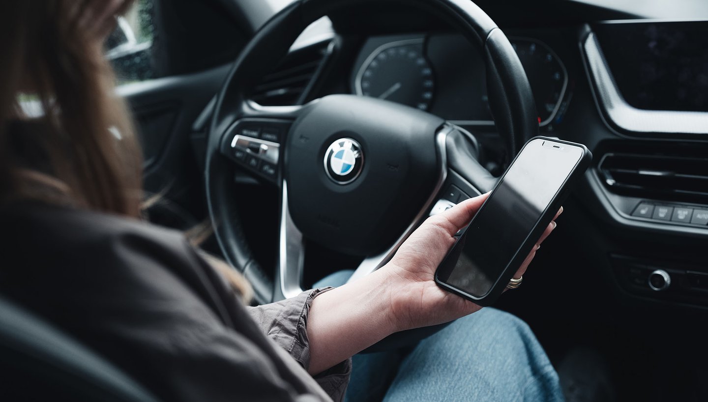 company-mileage-phone-in-car