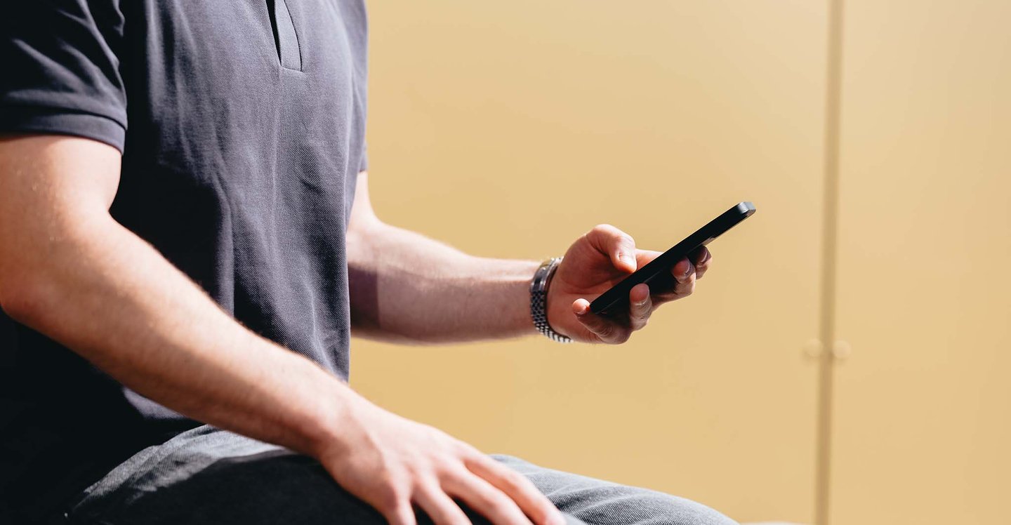 man-sitting-holding-phone