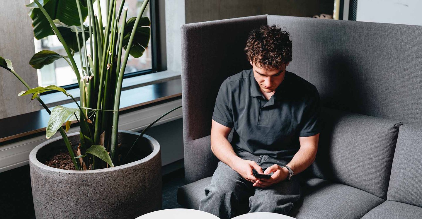 man-sitting-with-phone