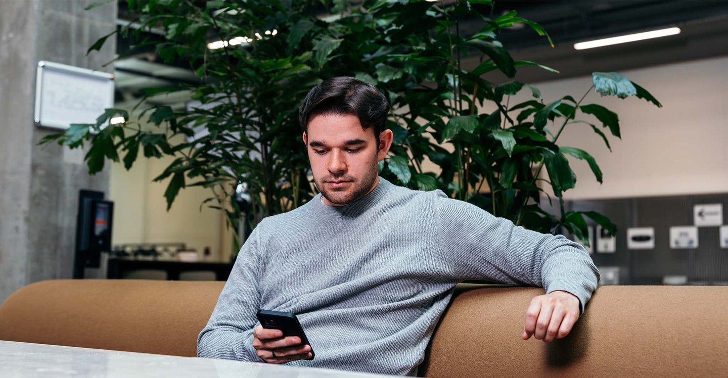 man-sitting-with-phone.sofa