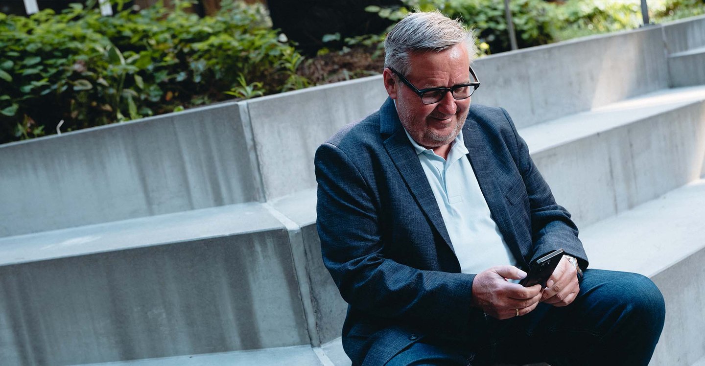 management-smilling-at-phone