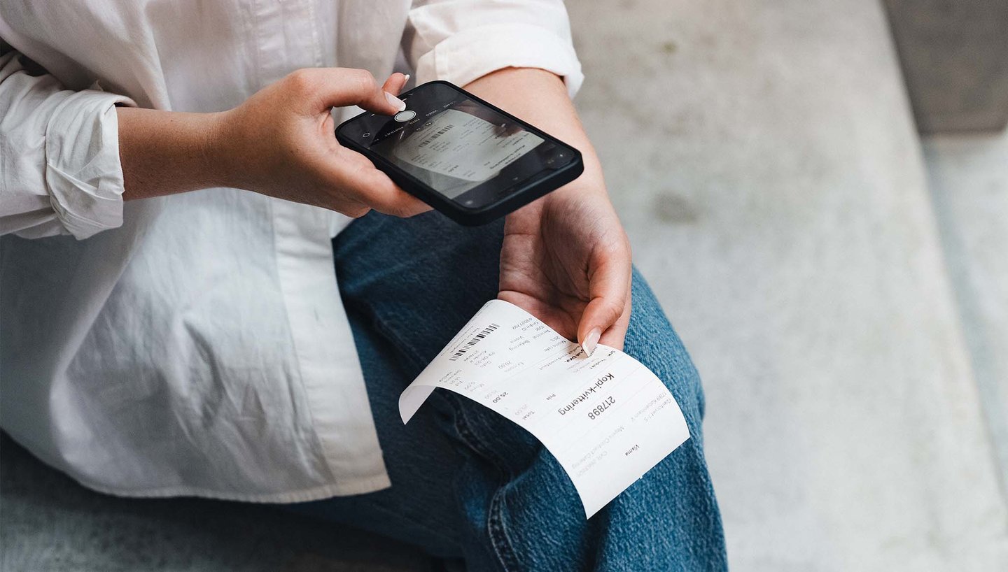 sitting-taking-picture-of-receipt