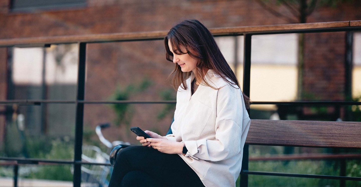 woman-with-phone-sitting-outside