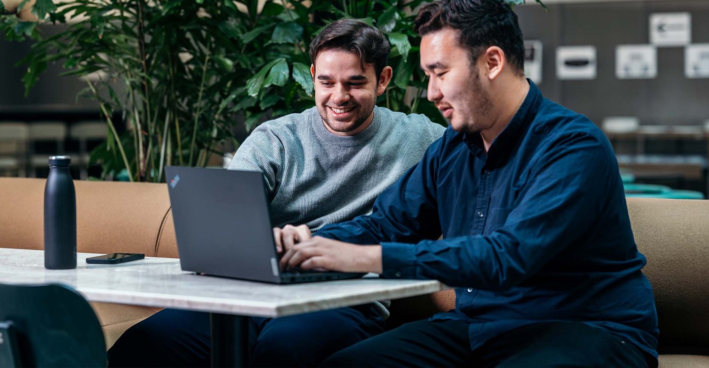 coworkers-smilling-and-seeing-the-computer