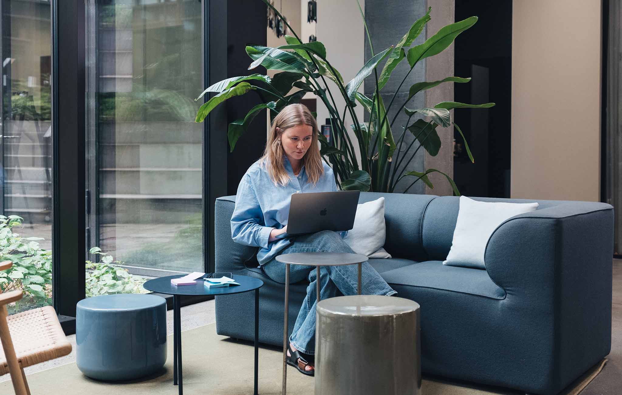 woman-sitting-with-macbook-on-sofa