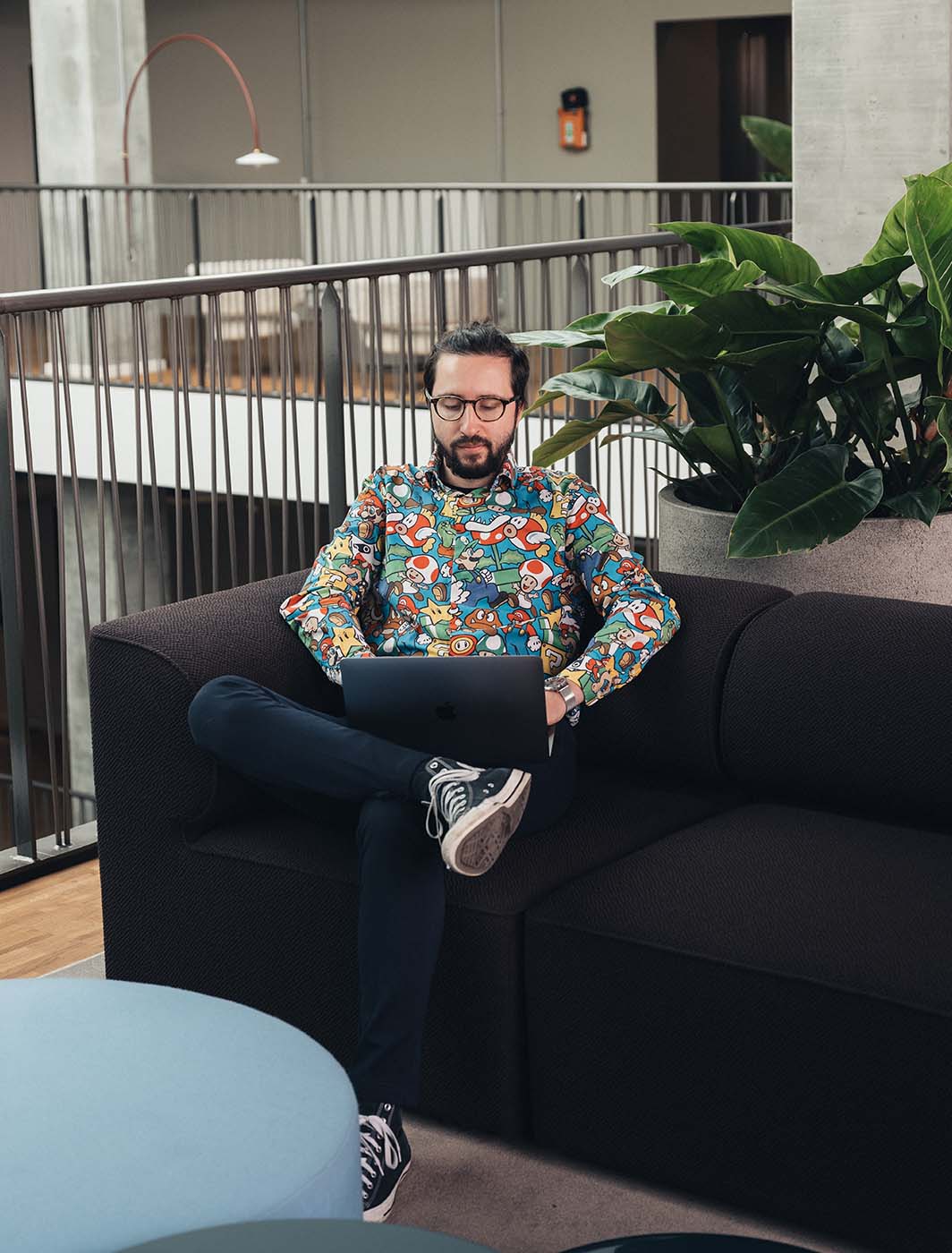 man-sitting-with-computer-on-sofa
