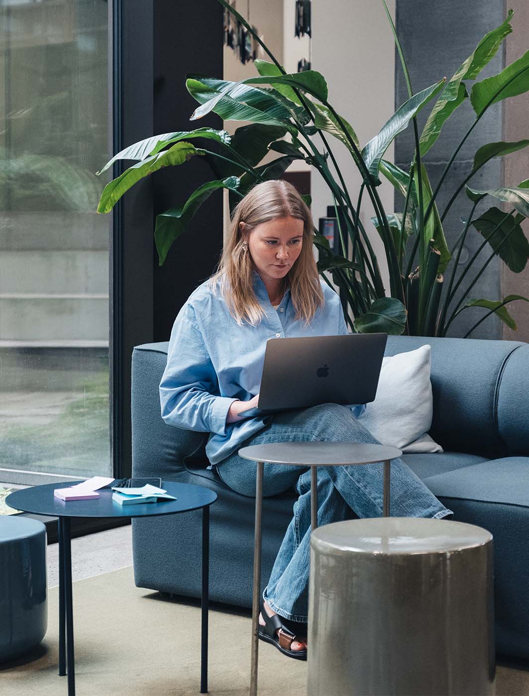 woman-sitting-with-computer-on-sofa