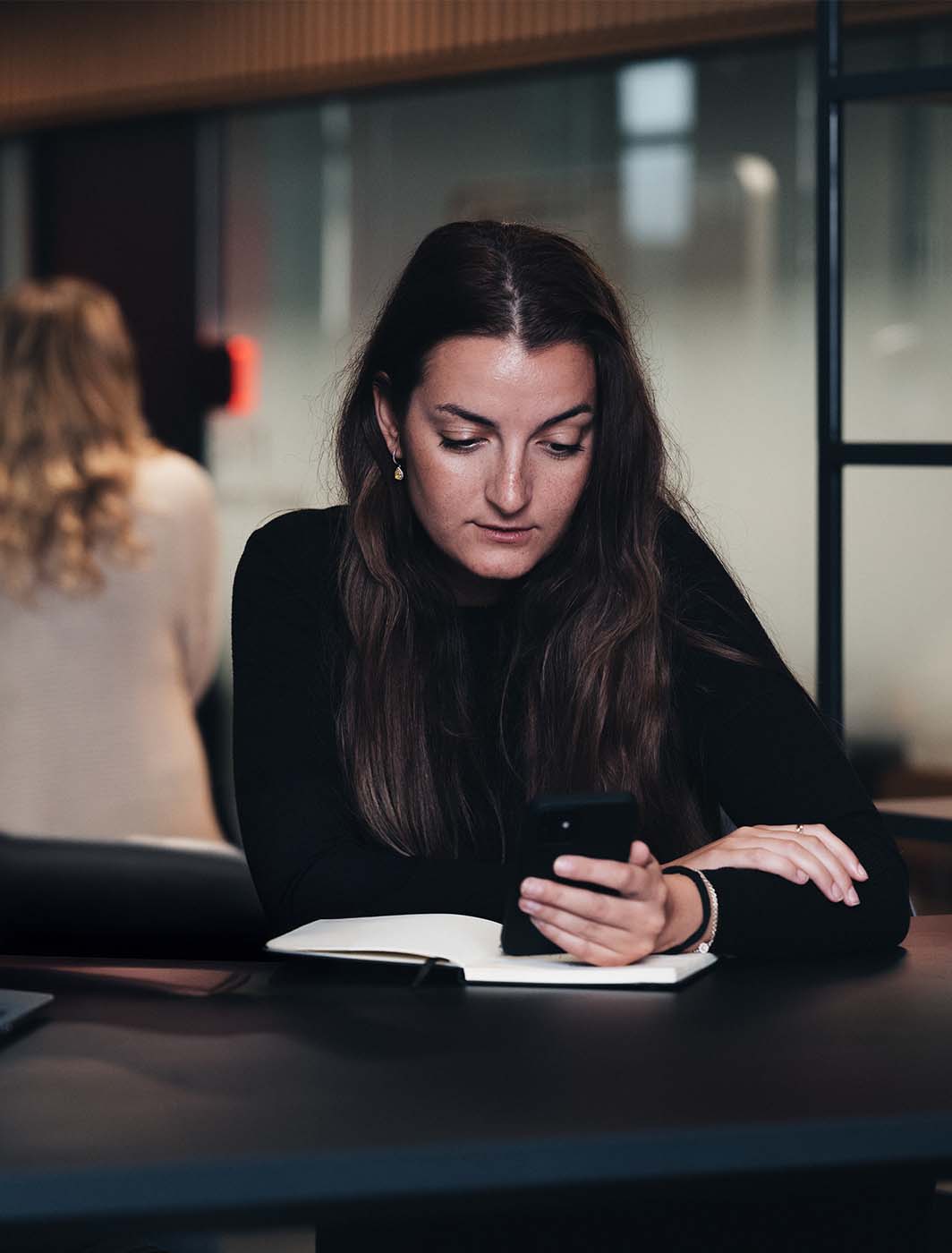 woman-sitting-with-phone