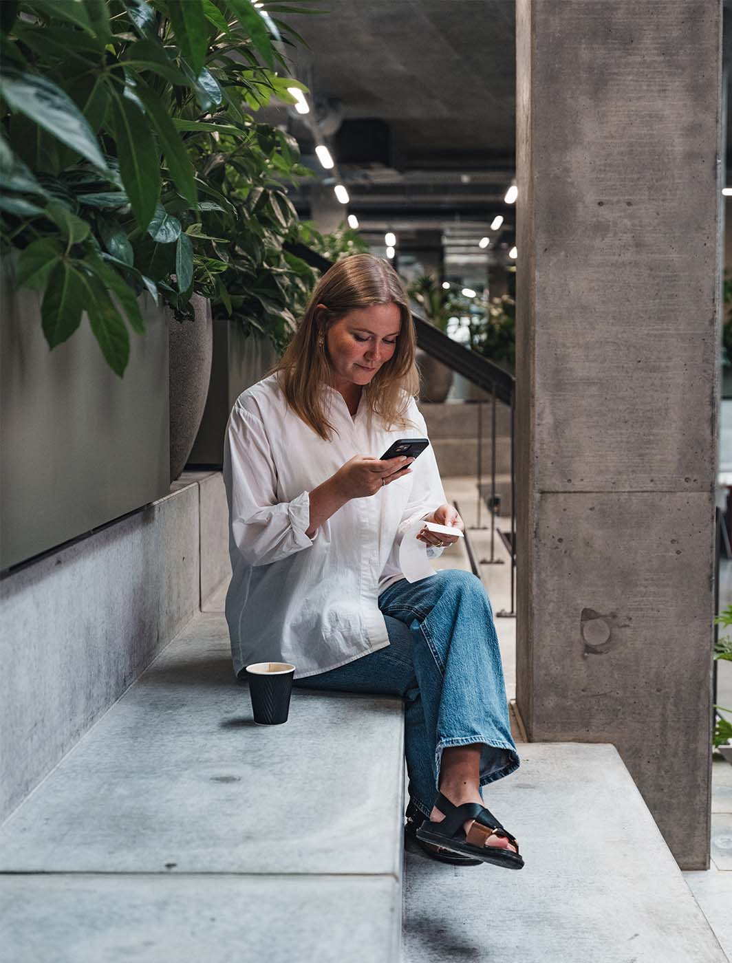 woman-taking-picture-of-receipt-coffee