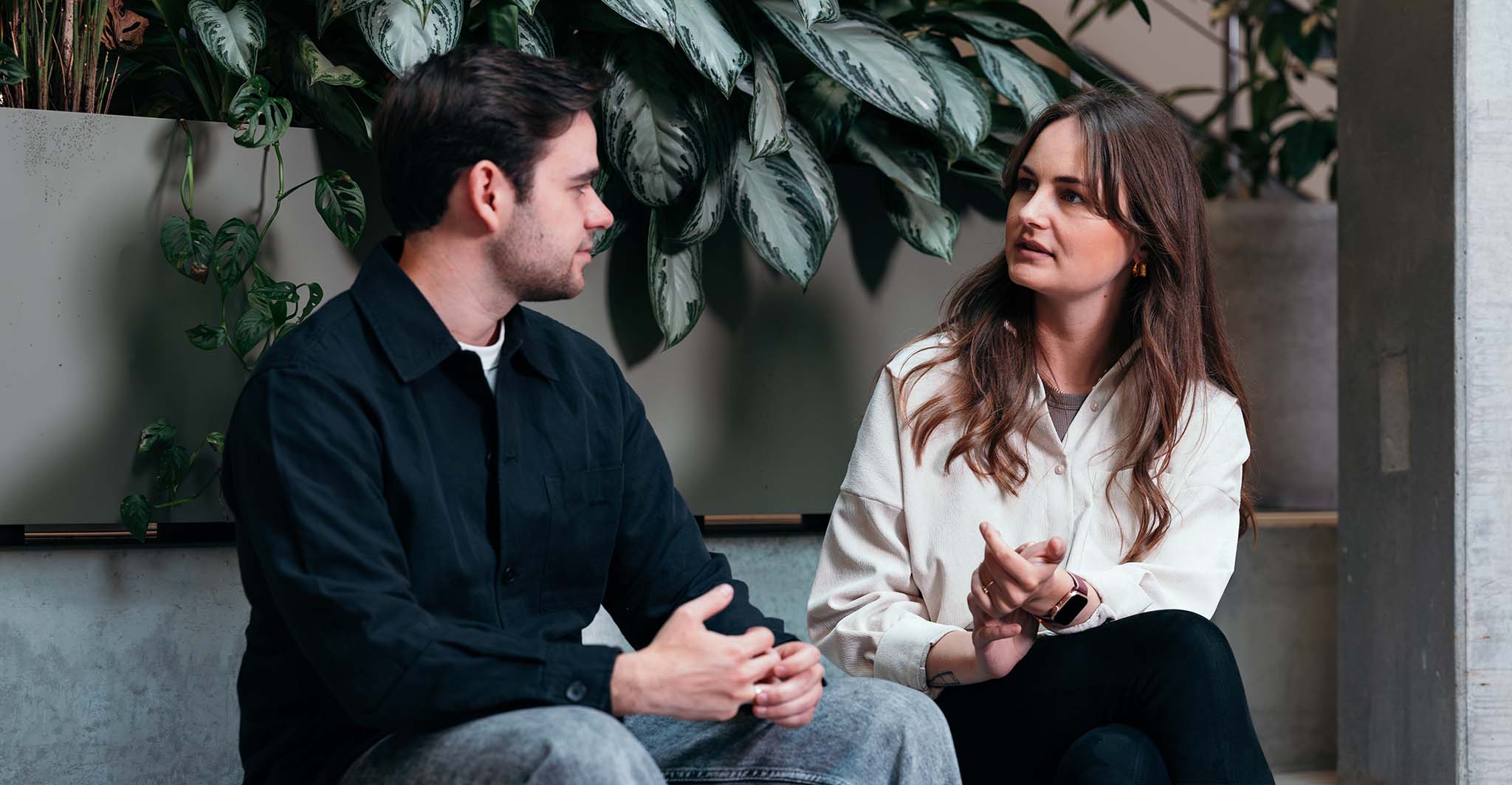 intrigued-coworkers-talking