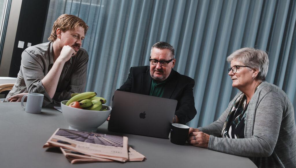 management sitting with computer