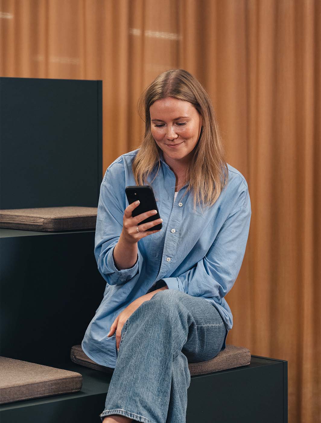 woman sitting with phone time registering